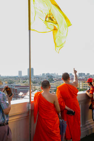 Buddhist monks watch Bangkok cityscape from the Golden Mountain, Thailandのeditorial素材