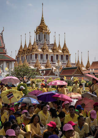 Thai people wear yellow shirts and are waiting for His Majesty King Maha Vajiralongkorn Bodindradebayavarangkun or King Rama X, near Wat Ratchanatdaram Woravihara (Loha Prasat), Bangkok, Thailandのeditorial素材