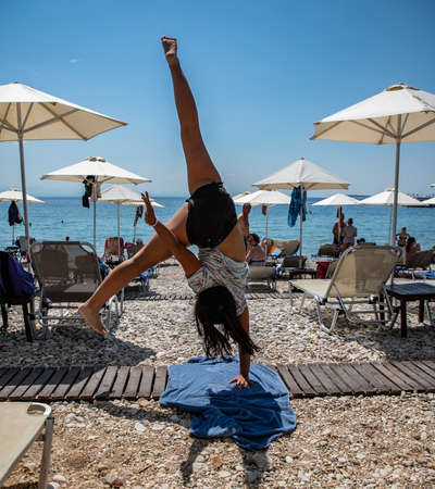young girl and her artistic gymnastics on the beach, Greeceのeditorial素材
