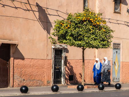 two women walk in the streets of Marrakesh wearing traditional Islamic clothes, Moroccoのeditorial素材