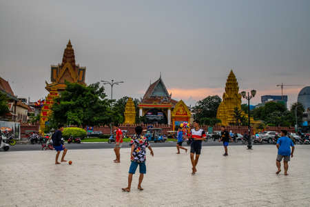 boys play football near Wat Ounalom, a famous historical site in Phnom Penh, Cambodiaのeditorial素材