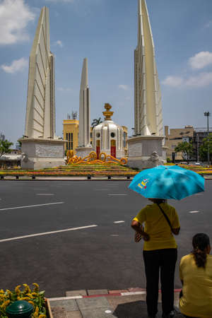 Thai people wear yellow shirts and with colored umbrellas and are waiting for His Majesty King Maha Vajiralongkorn Bodindradebayavarangkun or King Rama X, near Democracy Monument, Bangkok, Thailandのeditorial素材