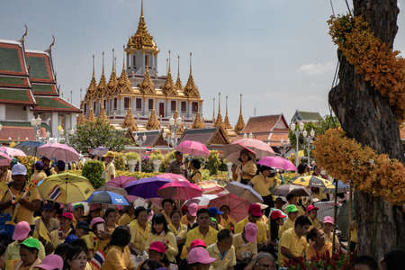 Thai people wear yellow shirts and are waiting for His Majesty King Maha Vajiralongkorn Bodindradebayavarangkun or King Rama X, near Wat Ratchanatdaram Woravihara (Loha Prasat), Bangkok, Thailandのeditorial素材