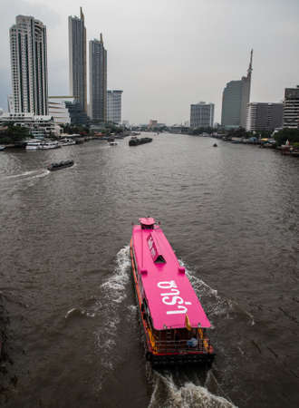 panoramic view of Bangkok (cityscape) with Chao Praya river and red boat, Bangkok, Thailandのeditorial素材