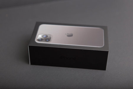Milan, Italy - December 17, 2019: close up on a brand new Apple iPhone 11 Pro on a black background, the original package from Apple is also visible.のeditorial素材