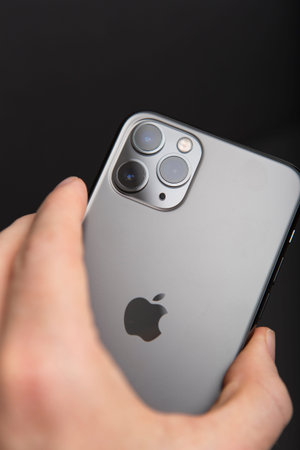 Milan, Italy - December 17, 2019: close up on a handheld brand new Apple iPhone 11 Pro on a black background.のeditorial素材