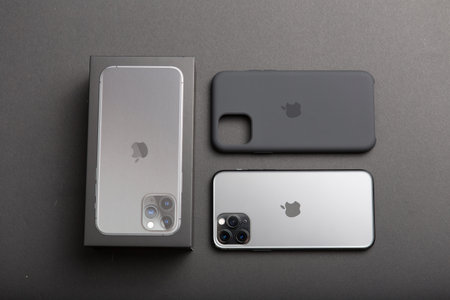 Milan, Italy - December 17, 2019: close up on a brand new Apple iPhone 11 Pro on a black background. Device in unboxed and a plastic cover lies close to it.のeditorial素材