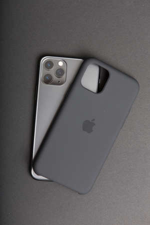 Milan, Italy - December 17, 2019: close up on a brand new Apple iPhone 11 Pro on a black background. Device in unboxed and a plastic cover lies close to it.のeditorial素材