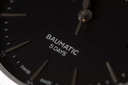 Milan, Italy - December 28, 2019: close up on a black Baume & Mercier man wristwatch, standing in its original package on black background.のeditorial素材