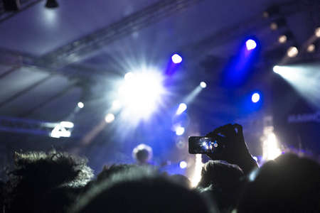 Raised hands silhouettes during a concertの写真素材