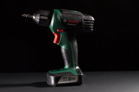 Milan, Italy - February 9, 2020: close up on a Bosch electric screwdriver, resting on a black...