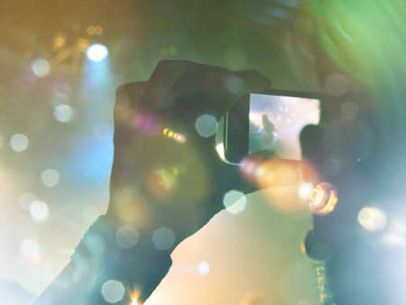 Shot taken during a music festival inside a concert hall. People are visible clapping the main stage.の写真素材