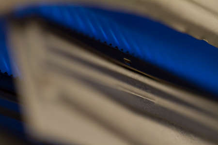 Close-up detail of a domestic gas water eater boiler, blue flames are visible inside.の写真素材