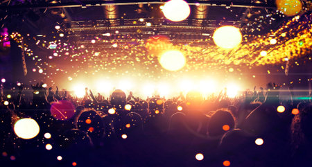 Concert crowd point of view inside a large concert hall during a music festival, the lit stage is...