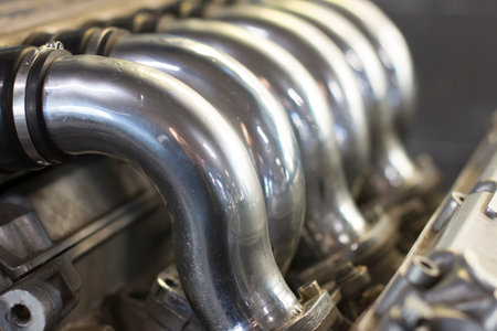 Close up on motor engine parts photographed indoor from a close distance, no people are visible.