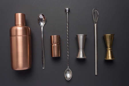 Flat lay with cocktail utensils on black background.の写真素材