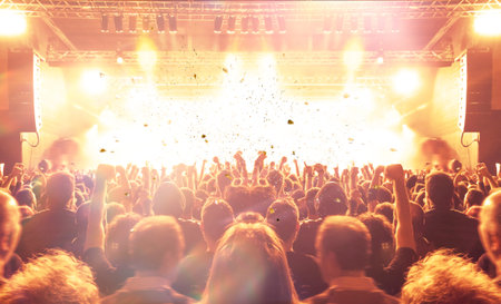 Music festival crowd, concert spectators in front of a bright stage with live music