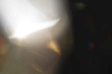 Lens flare and light leak haze texture on a black background.
