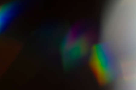 Lens flare and light leak haze texture on a black background.の写真素材