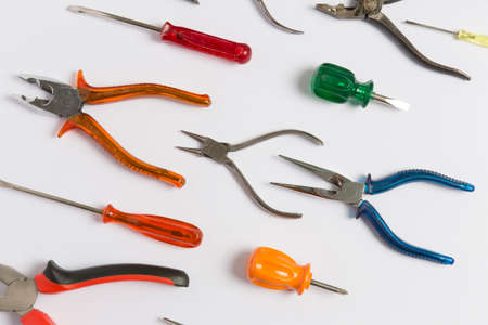 Flat lay composition with work tools made of iron resting on a white background.の写真素材