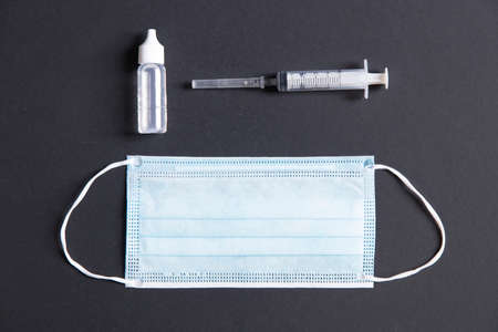 Close-up shot of a surgical respiratory mask against corona virus covid-19 infection, resting on a backdrop.の写真素材