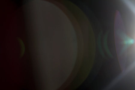 Colourful lens flare on black background.