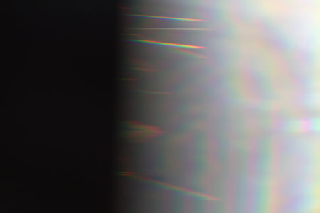Sun reflection over a piece of crystal for a colorful lens flare on black background