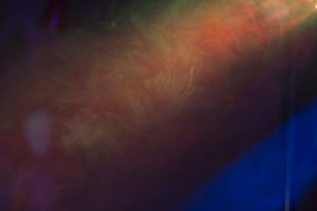 Abstract with coloured smoke on black background.