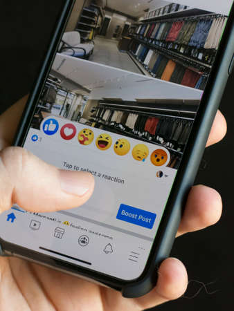 Milan, Italy - June 28, 2020: close up on a modern smarphone screen, newly introduced Facebook post reactions are visible on screen.のeditorial素材