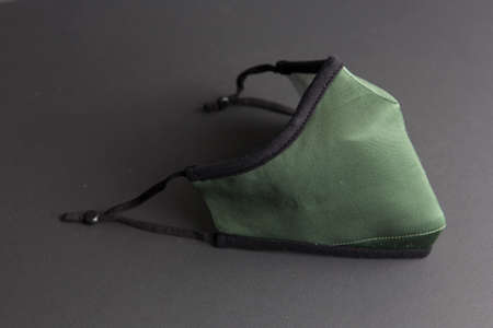 Close-up shot of a custom respiratory mask against COVID-19 coronavirus pandemic, no people are visible. Background is black.の写真素材