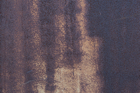 Front view of a rusty corroded metal plate for an abstract background texture.