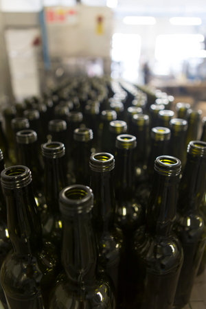Detail of a conveyor belt inside a facility production line for glass bottles. No people are visible.の写真素材