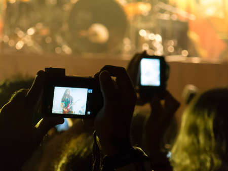Concert photography with a smartphone during a music festivalの写真素材