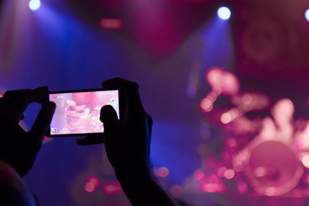 Concert photography with a smartphone during a music festivalの写真素材