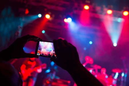 Concert photography with a smartphone during a music festivalの写真素材
