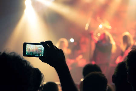 Concert photography with a smartphone during a music festivalの写真素材