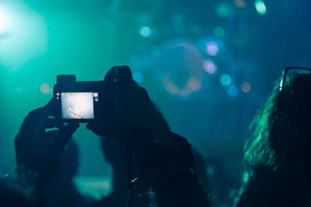 Concert photography with a smartphone during a music festivalの写真素材