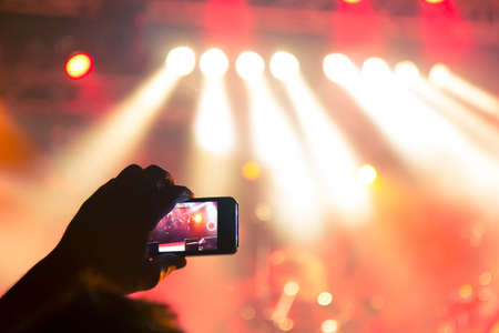 Concert photography with a smartphone during a music festivalの写真素材