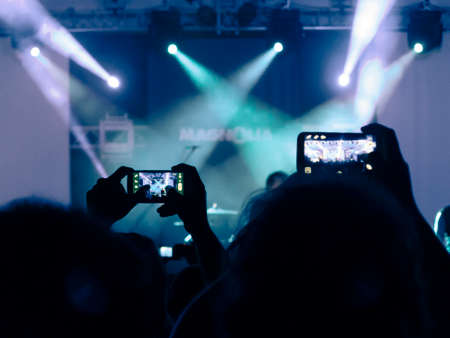 Close up on a welding machine in action, handheld by a worker wearing protective gloves.の写真素材