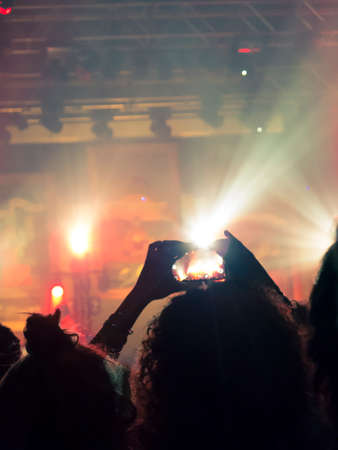 Concert photography with a smartphone during a music festivalの写真素材