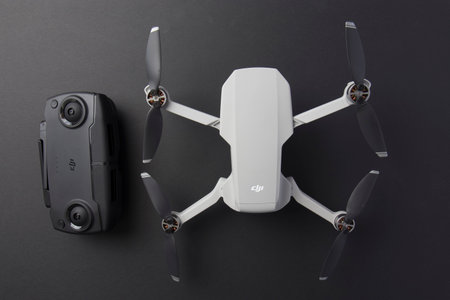 Milan, Italy - July 25, 2020: close up on a DJI Mavic Mini drone resting on a black background, no...