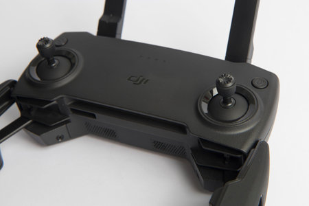 Milan, Italy - July 25, 2020: close up on a DJI Mavic Mini drone remote controller resting on a...