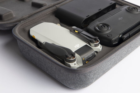Milan, Italy - July 25, 2020: close up on a DJI Mavic Mini drone case resting on a white background,...