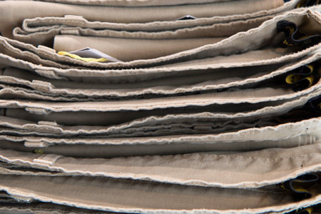 Close up detail of clothes hanging inside a closet, no people are visible.の写真素材