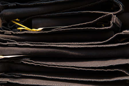 Close up detail of clothes hanging inside a closet, no people are visible.の写真素材