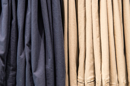 Close up detail of clothes hanging inside a closet, no people are visible.