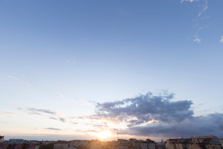 Wide angle view of a sunset over a dark city.