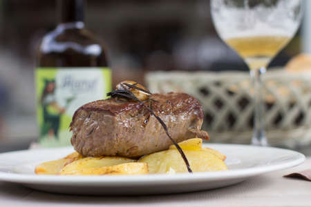 Close up detail of a fillet steak resting on a restaurant table, background is blurred.の写真素材