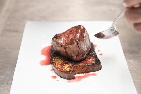 Beef fillet with foie gras, served on a restaurant dish.