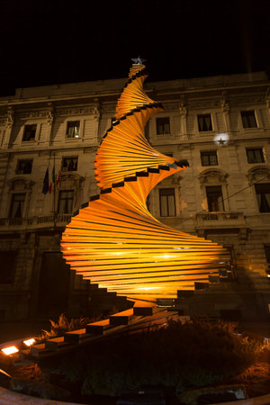 Milan, Italy - December 10, 2020: street view of the Christmas tree in Galleria Vittorio Emanuele at night, few people are barely visible in the distance.のeditorial素材